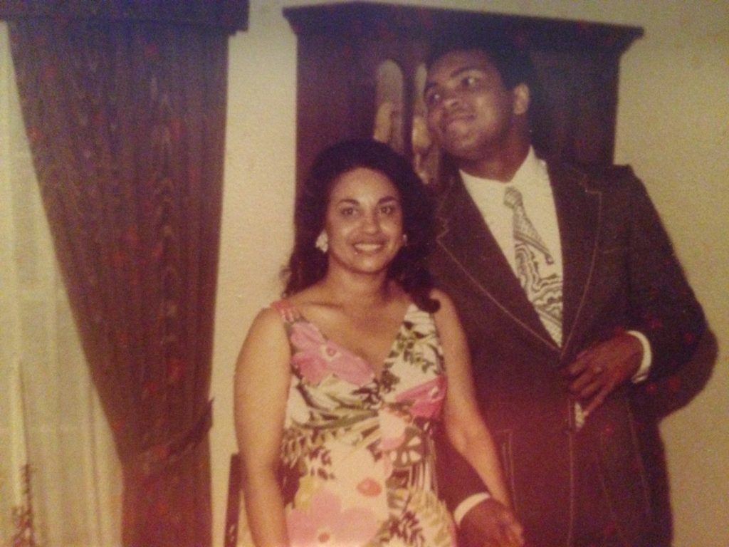 Muhammad Ali, with Betty Casem, peaks over to see himself in the mirror.